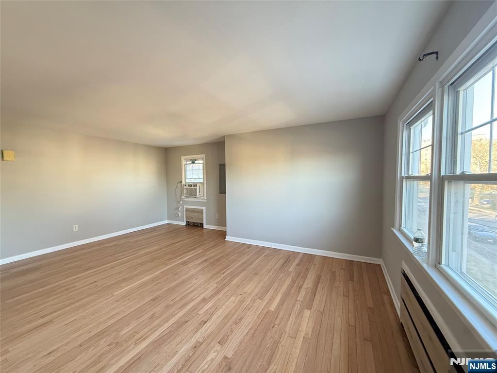 175 Van Winkle Street, Unit 2 East Rutherford, NJ 07073 - Photo 7 of 20 wooden floor in an empty room with a window