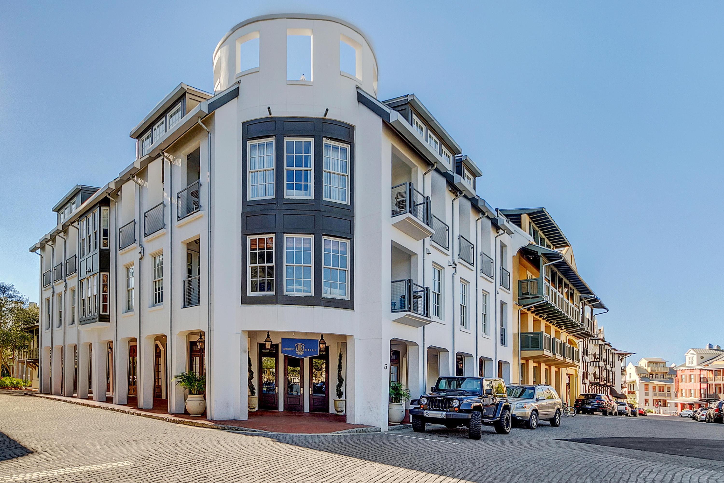 a couple of cars parked in front of brick building