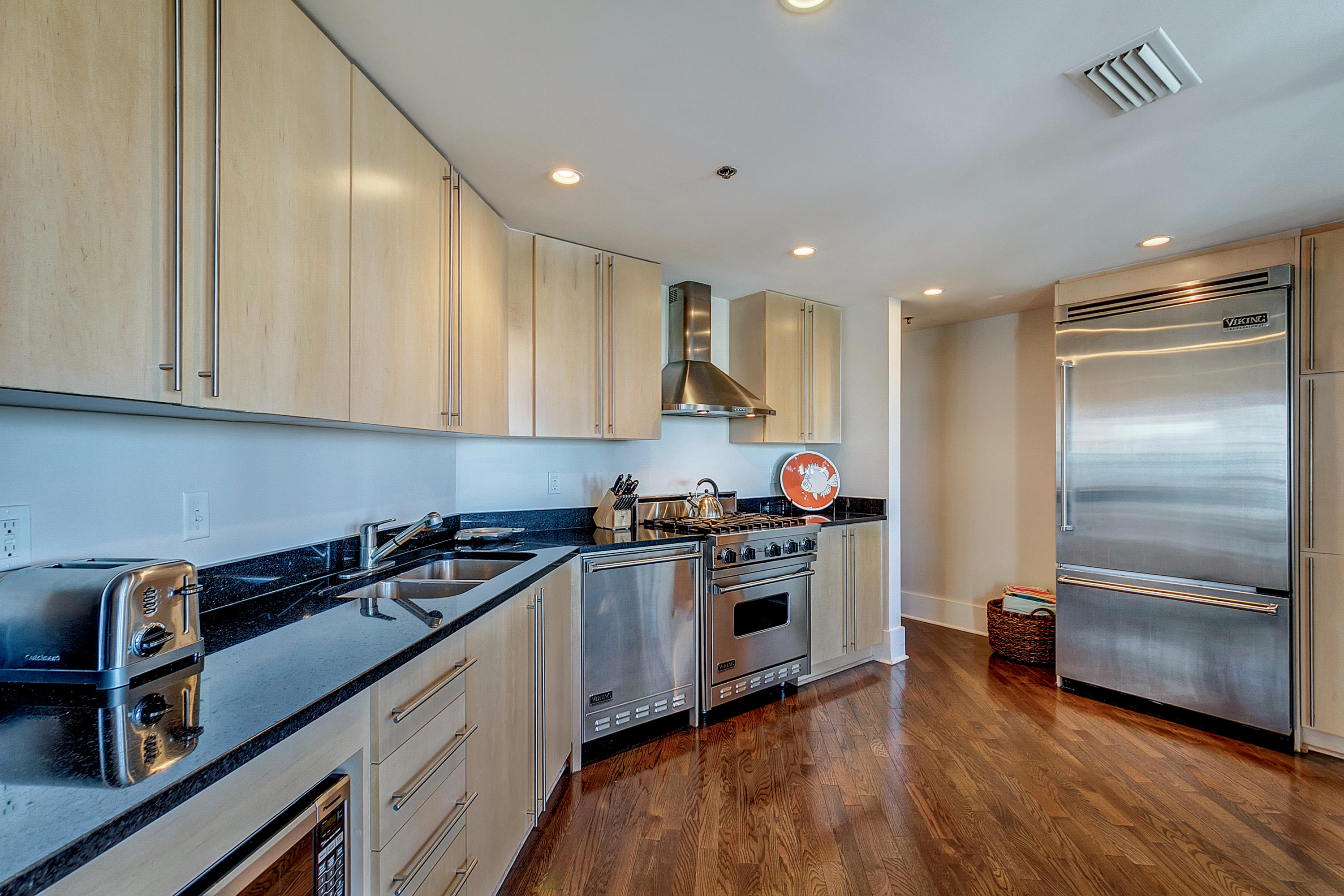 5 Main Street, Unit 1F Rosemary Beach, FL 32461 - Photo 11 of 24 a kitchen with kitchen island granite countertop a stove and a refrigerator