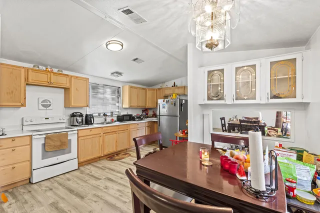 a kitchen with lots of counter top space and wooden floor