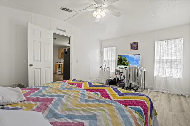 a bedroom with a bed and a chandelier