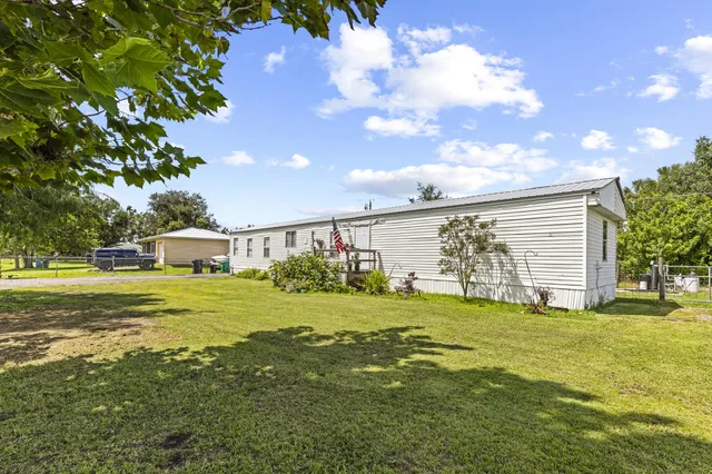 a view of a big yard with a house