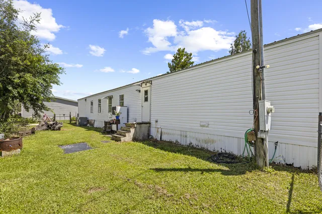 a backyard of a house with table and chairs