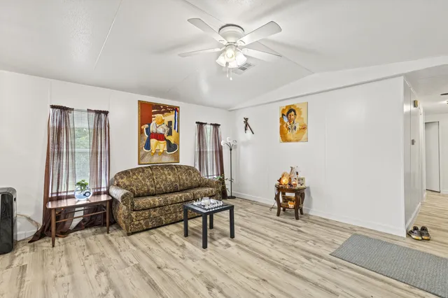 a living room with furniture and wooden floor