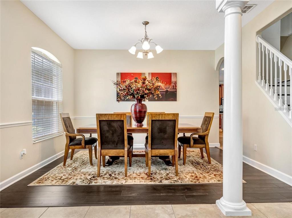 10023 Ians Ridge Road Orlando, FL 32832 - Photo 6 of 60 a living room with furniture and a chandelier