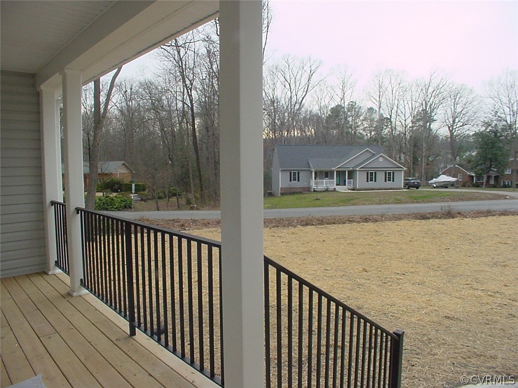 Covered front porch with metal handrails