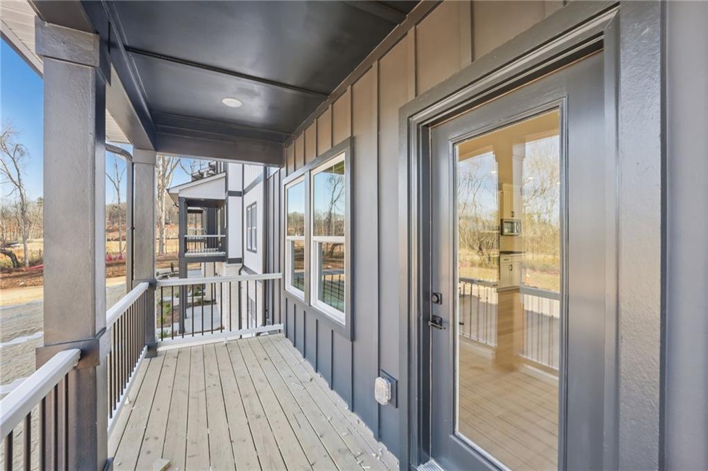 6440 Pinin Place Cumming, GA 30041 - Photo 6 of 52 a view of a balcony with wooden floor