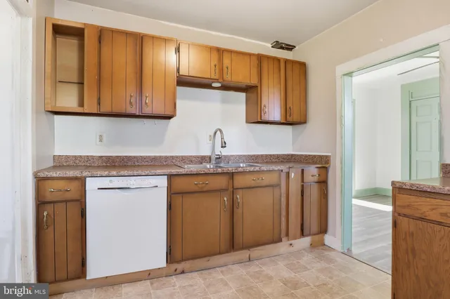 a kitchen with a sink and a refrigerator
