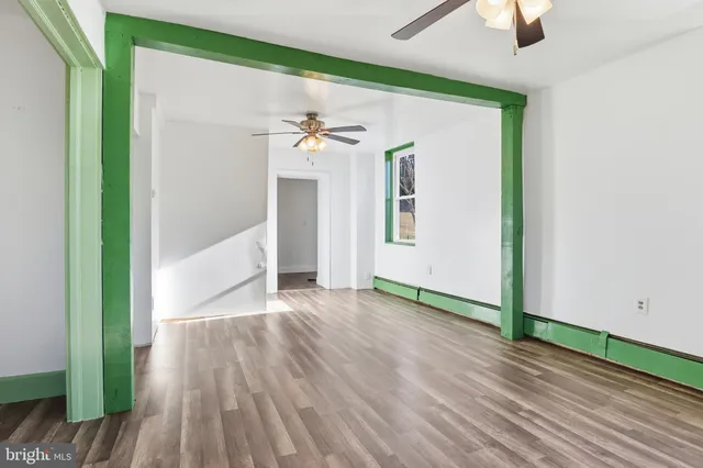 wooden floor in an empty room with a window