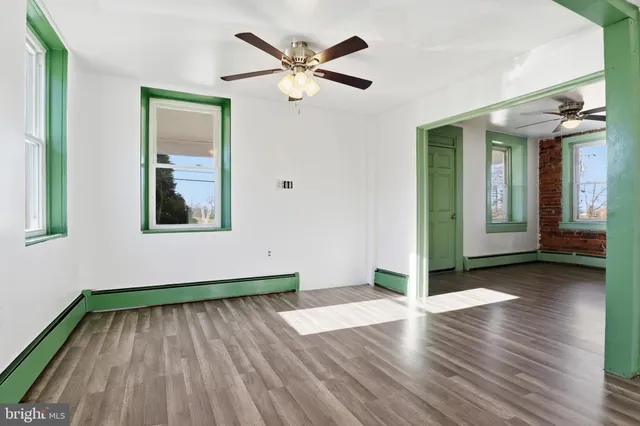 wooden floor in an empty room with a window