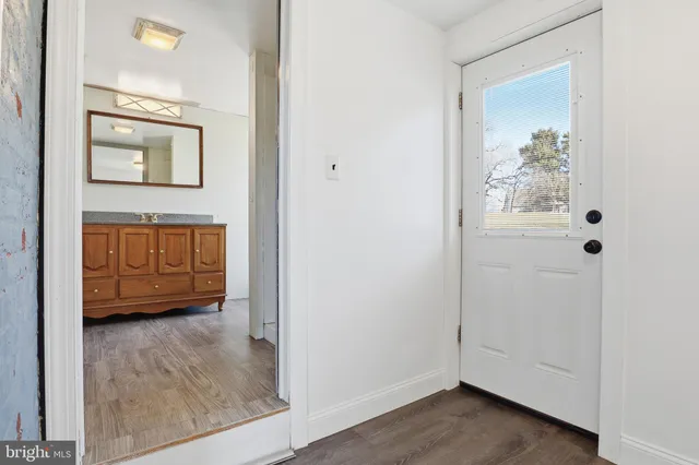 a bathroom with a granite countertop sink a toilet and a mirror