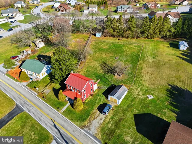 an aerial view of residential houses with yard