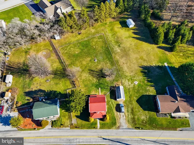 an aerial view of residential houses with outdoor space and swimming pool