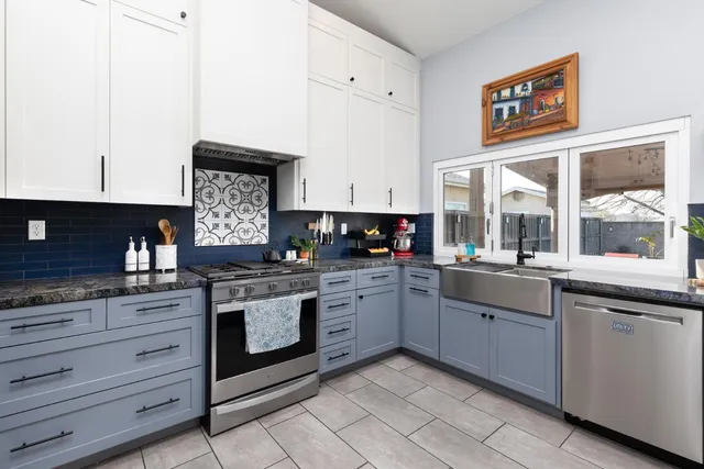 a kitchen with stainless steel appliances granite countertop a stove and a sink