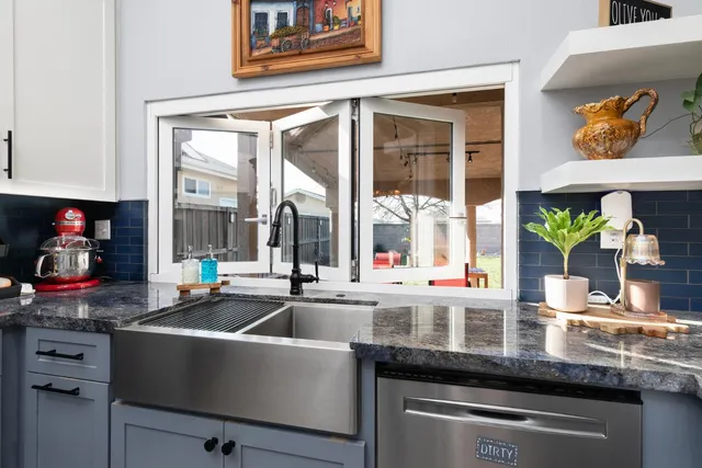 a kitchen counter with a sink and cabinets