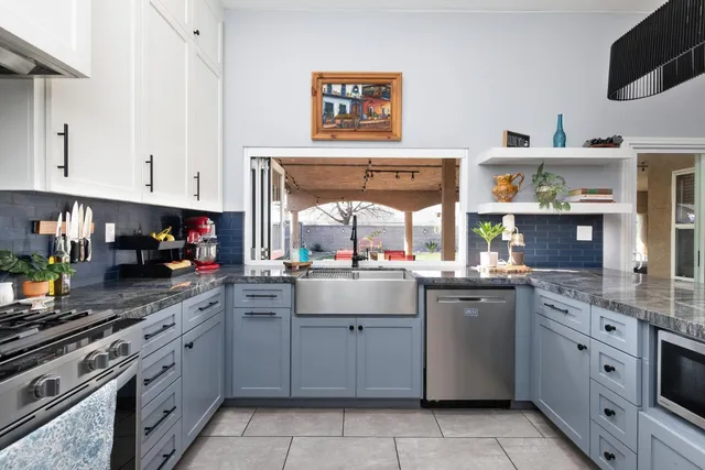 a kitchen with stainless steel appliances granite countertop a sink and cabinets