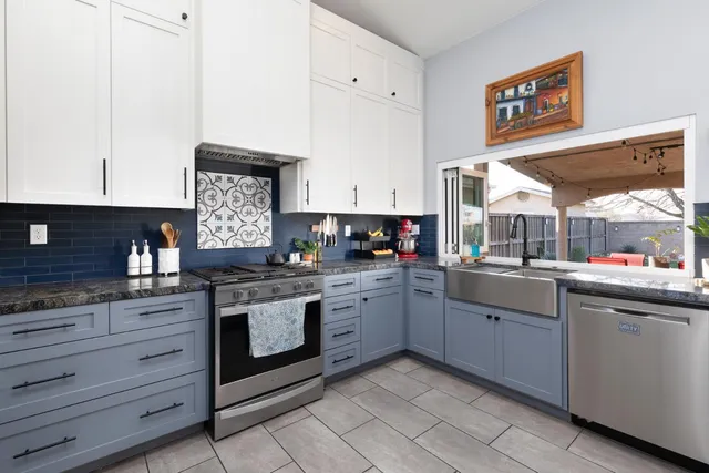 a kitchen with stainless steel appliances granite countertop a stove and a sink