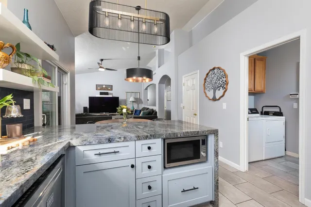 a kitchen with stainless steel appliances granite countertop a stove a microwave and cabinets