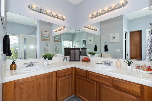 a bathroom with a sink double vanity and a mirror