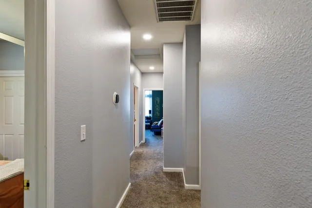 a view of a hallway with wooden shelves