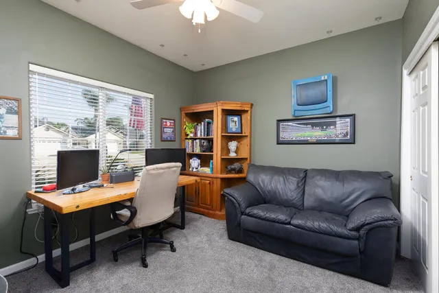 a workspace with furniture and a flat screen tv