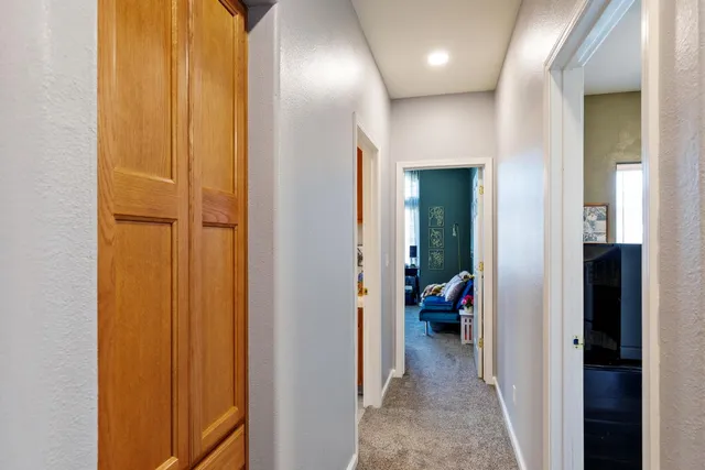 a view of a hallway with wooden shelves