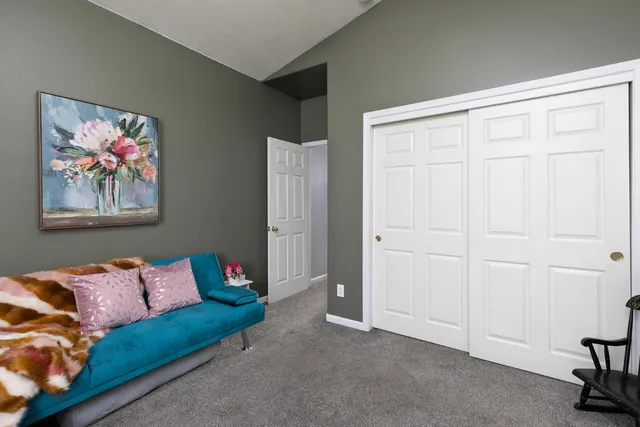 a living room with furniture and a air conditioner vent
