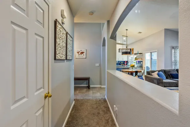 a view of a hallway with living room