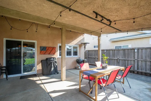 a view of a patio with table and chairs and potted plants