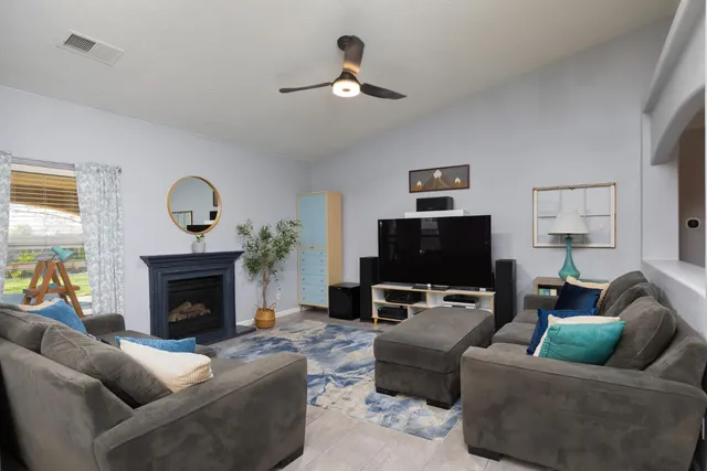 a living room with furniture and a fireplace