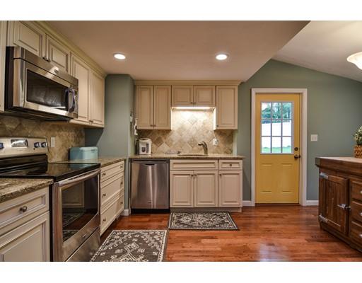 15 Hadley Road Framingham, MA 01701 - Photo 8 of 26 a kitchen with stainless steel appliances granite countertop a stove a sink and a microwave