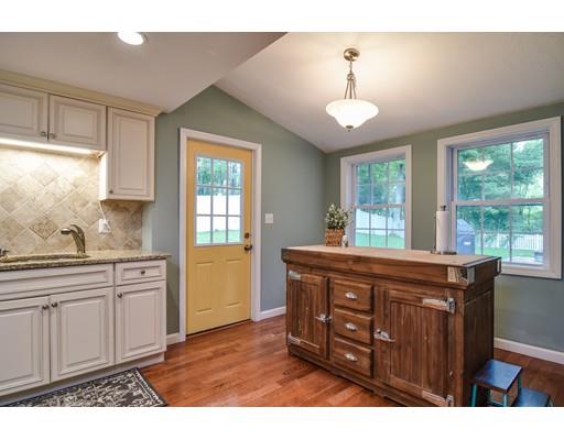 15 Hadley Road Framingham, MA 01701 - Photo 9 of 26 a kitchen with stainless steel appliances granite countertop a stove a sink dishwasher and a microwave oven with wooden floor