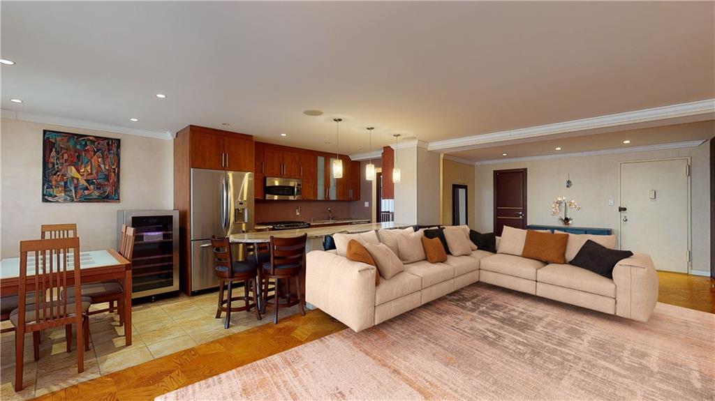 a living room with furniture and a dining table with kitchen view