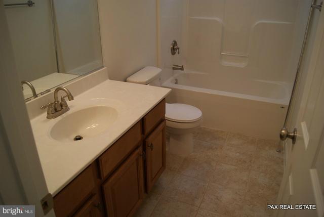 4430 Solomons Island Road Huntingtown, MD 20639 - Photo 2 of 17 a bathroom with a sink mirror vanity and toilet