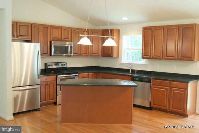 4430 Solomons Island Road Huntingtown, MD 20639 - Photo 12 of 17 a kitchen with stainless steel appliances granite countertop a sink stove and refrigerator