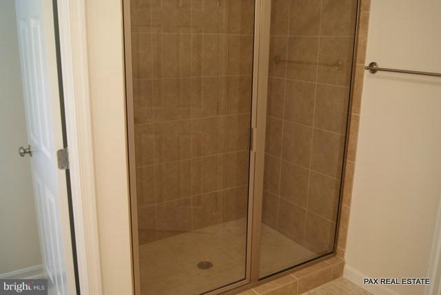 4430 Solomons Island Road Huntingtown, MD 20639 - Photo 13 of 17 a bathroom with a glass shower door