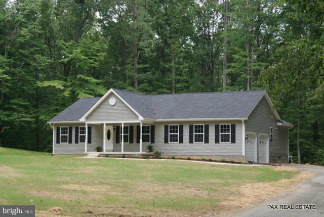4430 Solomons Island Road Huntingtown, MD 20639 - Photo 14 of 17 a front view of a house with a garden