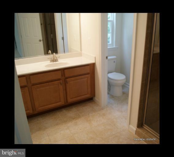 4430 Solomons Island Road Huntingtown, MD 20639 - Photo 16 of 17 a bathroom with a sink and a mirror