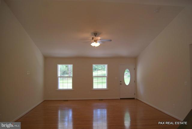 4430 Solomons Island Road Huntingtown, MD 20639 - Photo 4 of 17 an empty room with wooden floor and windows