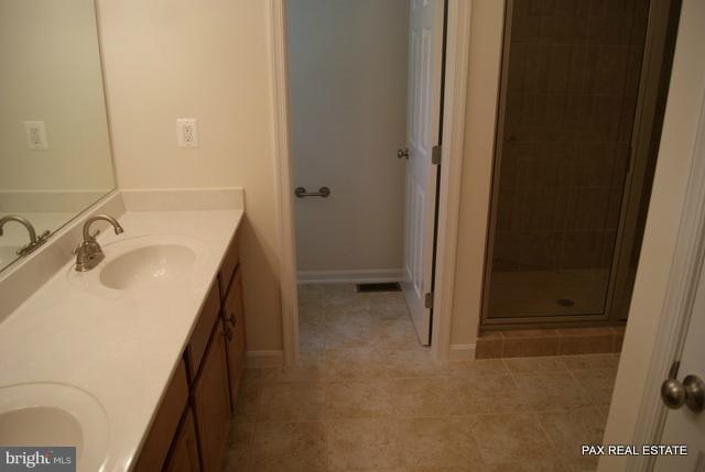 4430 Solomons Island Road Huntingtown, MD 20639 - Photo 9 of 17 a bathroom with a sink a toilet and shower