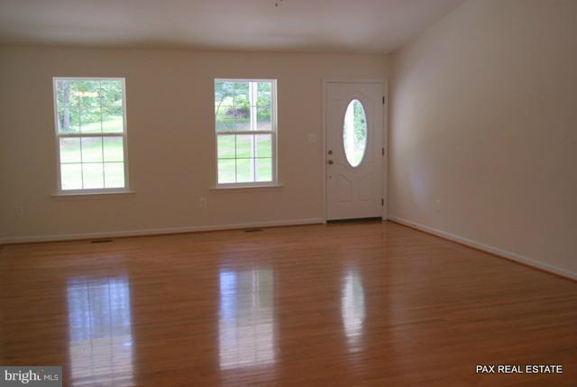 4430 Solomons Island Road Huntingtown, MD 20639 - Photo 10 of 17 an empty room with wooden floor and windows