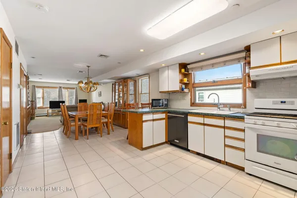 a kitchen with stainless steel appliances granite countertop a refrigerator sink and stove