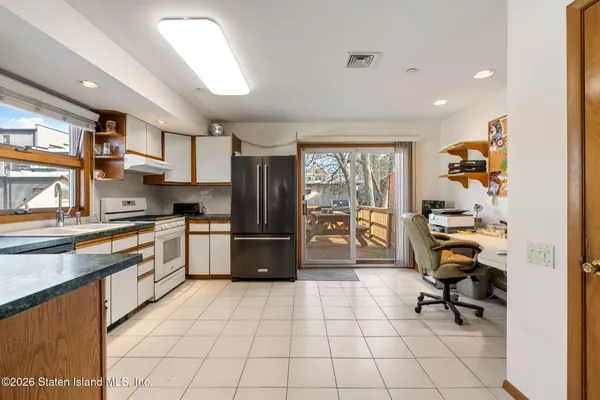 a view of a hallway with wooden cabinet and glass door