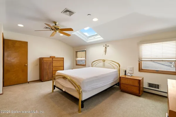 a bedroom with a bed and a ceiling fan