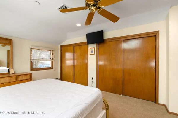 a bedroom with a bed and a dresser