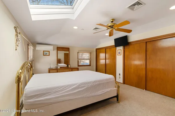 a bed room with a bed and a chair