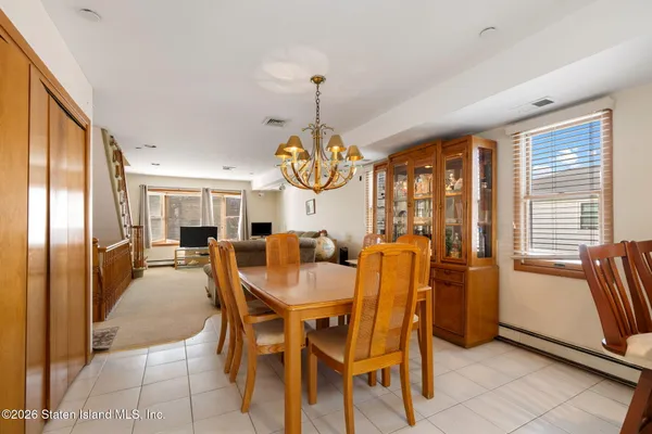 a dining hall with stainless steel appliances granite countertop a refrigerator and a sink