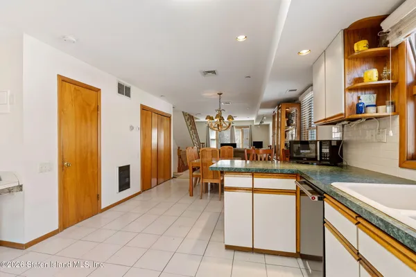 a kitchen with cabinets and chairs