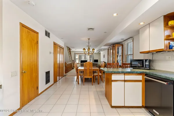 a kitchen with a sink a counter top space cabinets stainless steel appliances and a large window