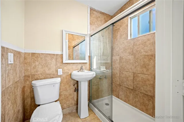 a bathroom with a sink a toilet and bathtub